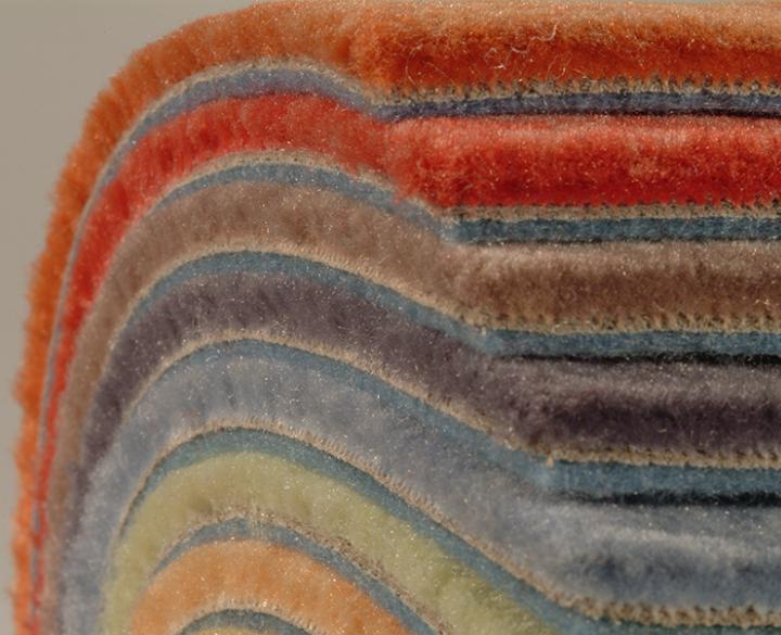 stack of colorful carpets